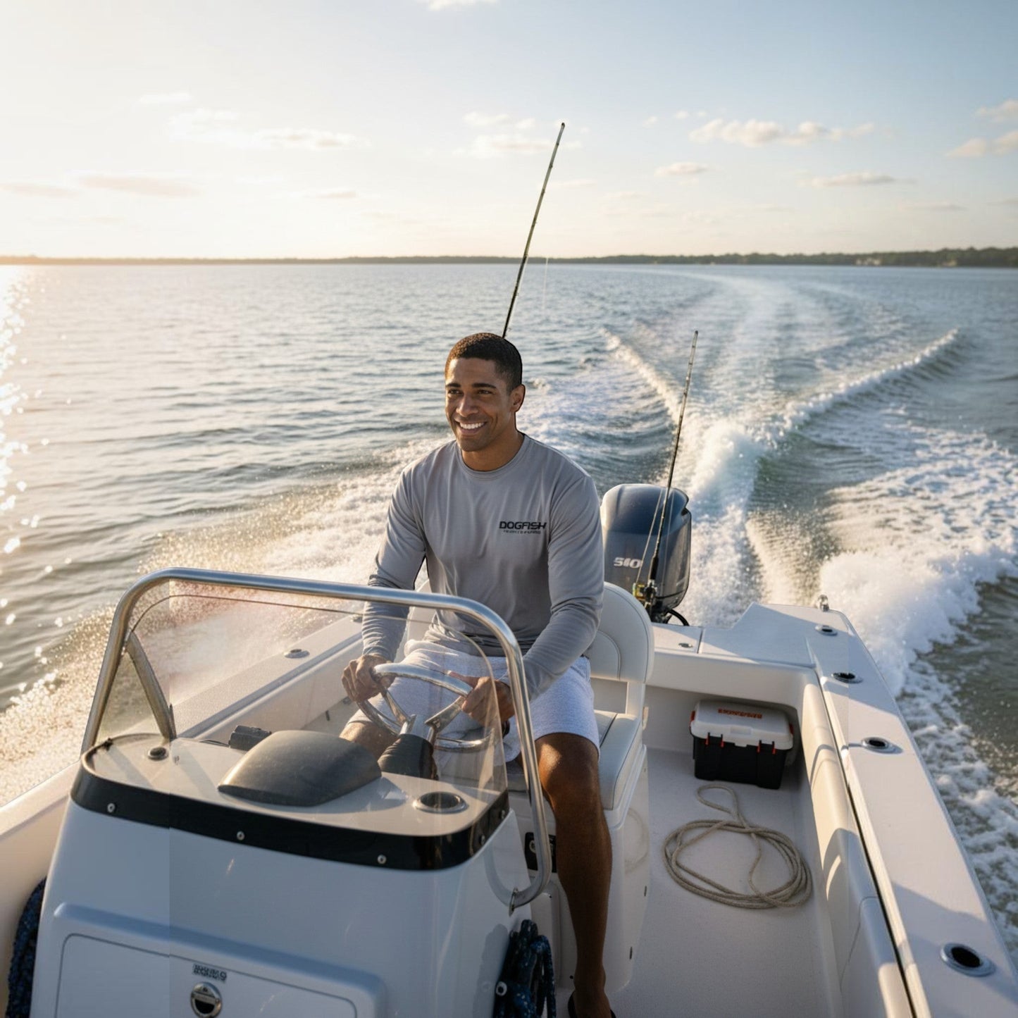 Man on a boat in the water with a clear sky