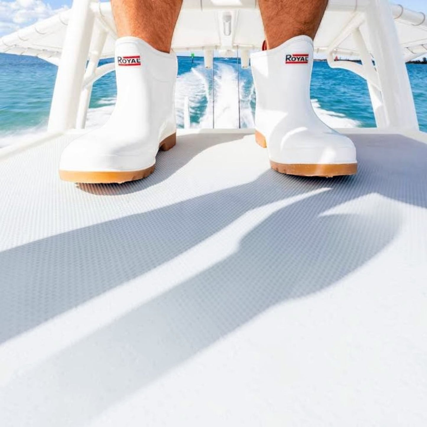 Dogfish Tackle & Marine Royal Mens 6in white waterproof PVC deck boots with deep tread soles worn on a boat deck