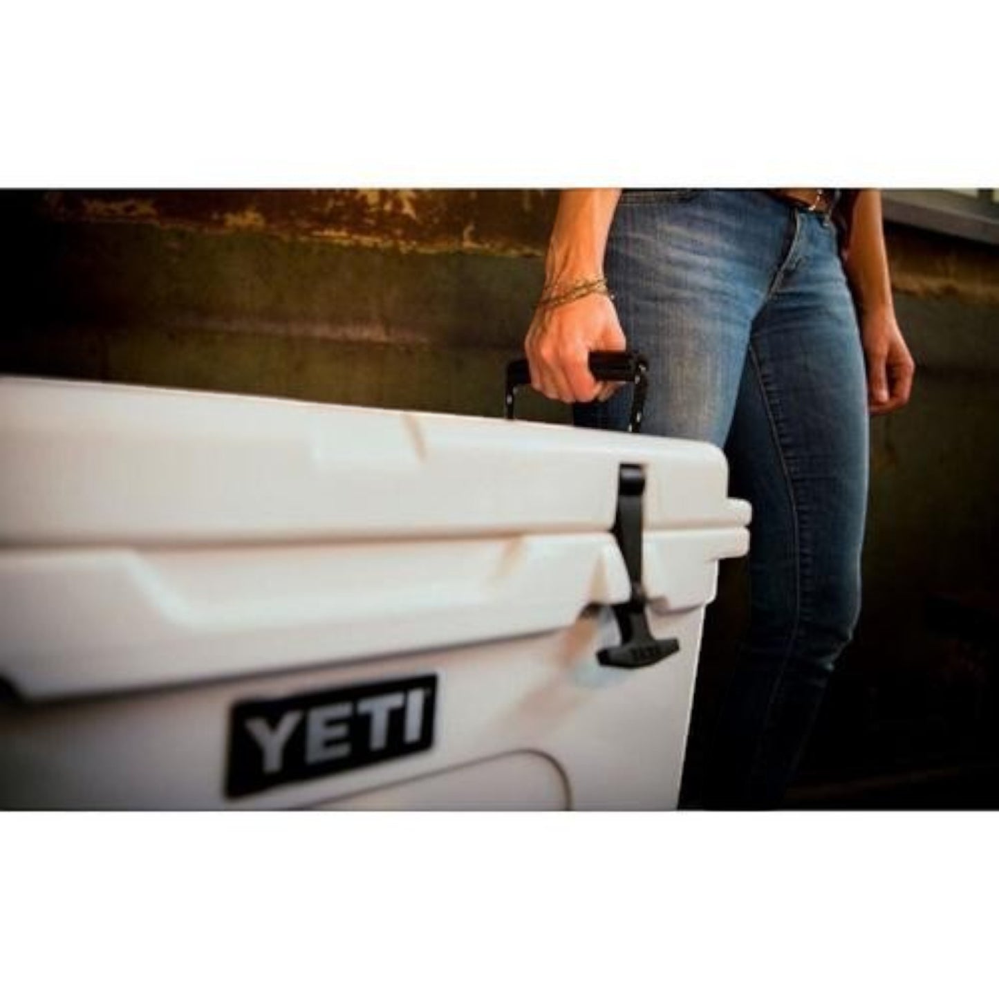 Dogfish Tackle & Marine Yeti Tundra 50 white rotomolded hard cooler being carried by a person in jeans