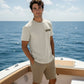 Man standing on a boat with ocean and sky in the background