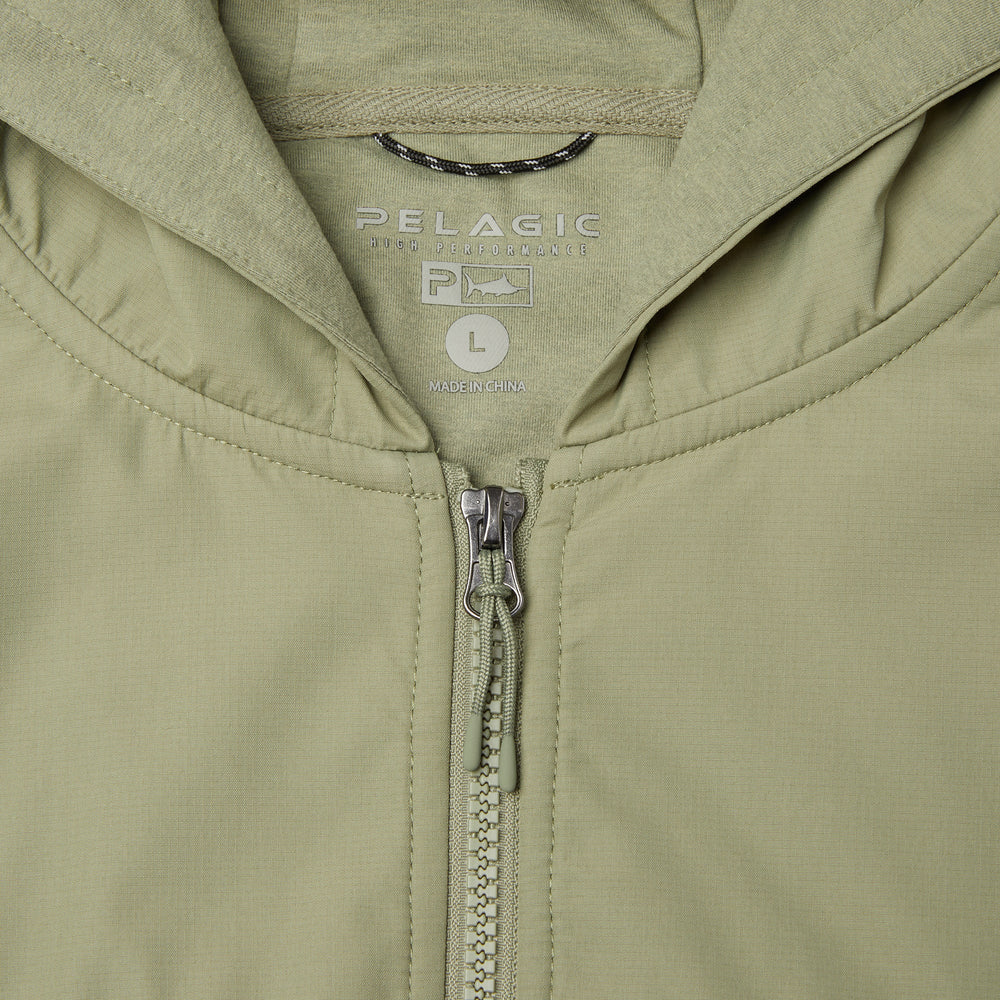 Close-up of a hooded zip-front jacket in a light sage green color, showing the inner neck label with 'PELAGIC' and size 'L'.