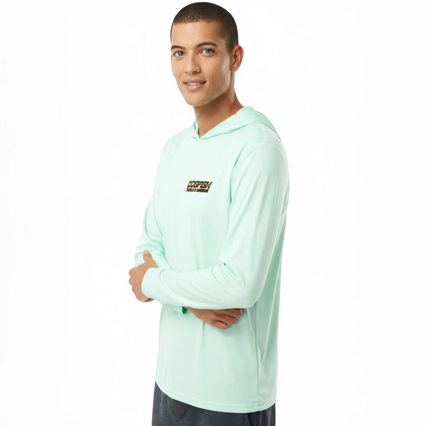 Person wearing a light green long-sleeve shirt with a brand logo on a white background