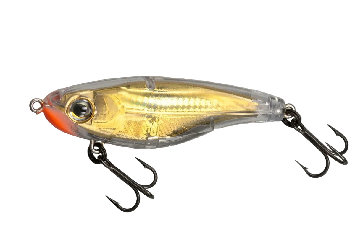 A gold and clear plastic fishing lure with a bright orange-red tail and black treble hooks, shown on a neutral gray background.