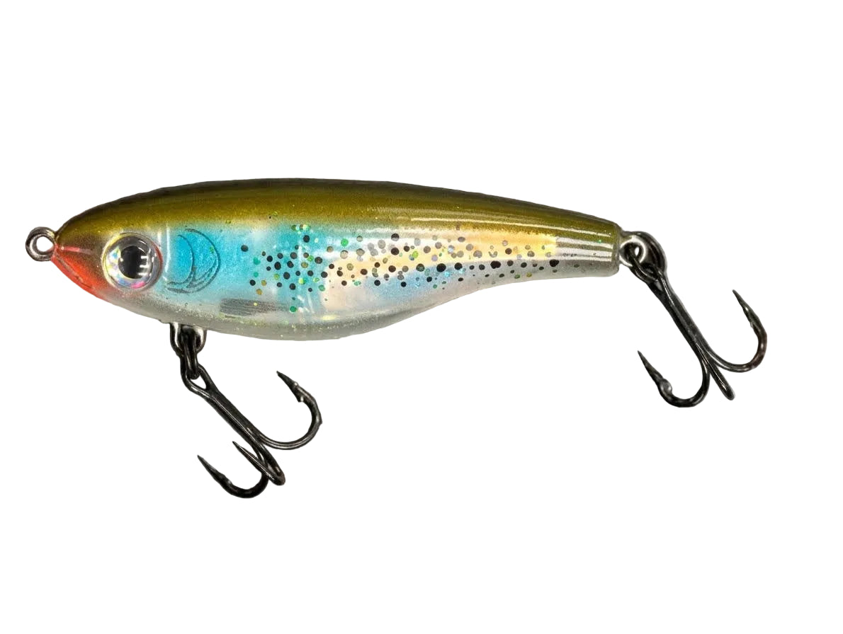 A trout-shaped fishing lure with two treble hooks, shown on a textured gray background with the word 'TROUT' printed in black text in the upper left.