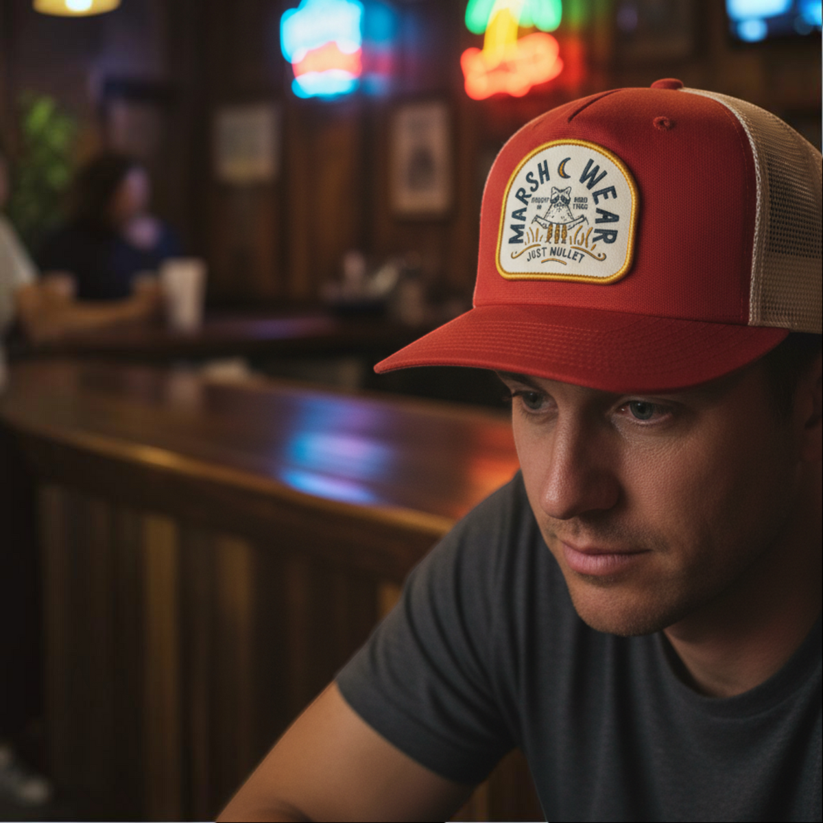 Dogfish Tackle & Marine Marsh Wear red and tan cotton canvas trucker hat with a woven campfire patch on a man