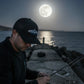 Dogfish Tackle & Marine black mesh back hat with embroidered logo, worn by a man fishing at night under a full moon.