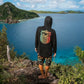 Dogfish Tackle & Marine black long-sleeve rashguard with colorful graphic on back, paired with patterned boardshorts.