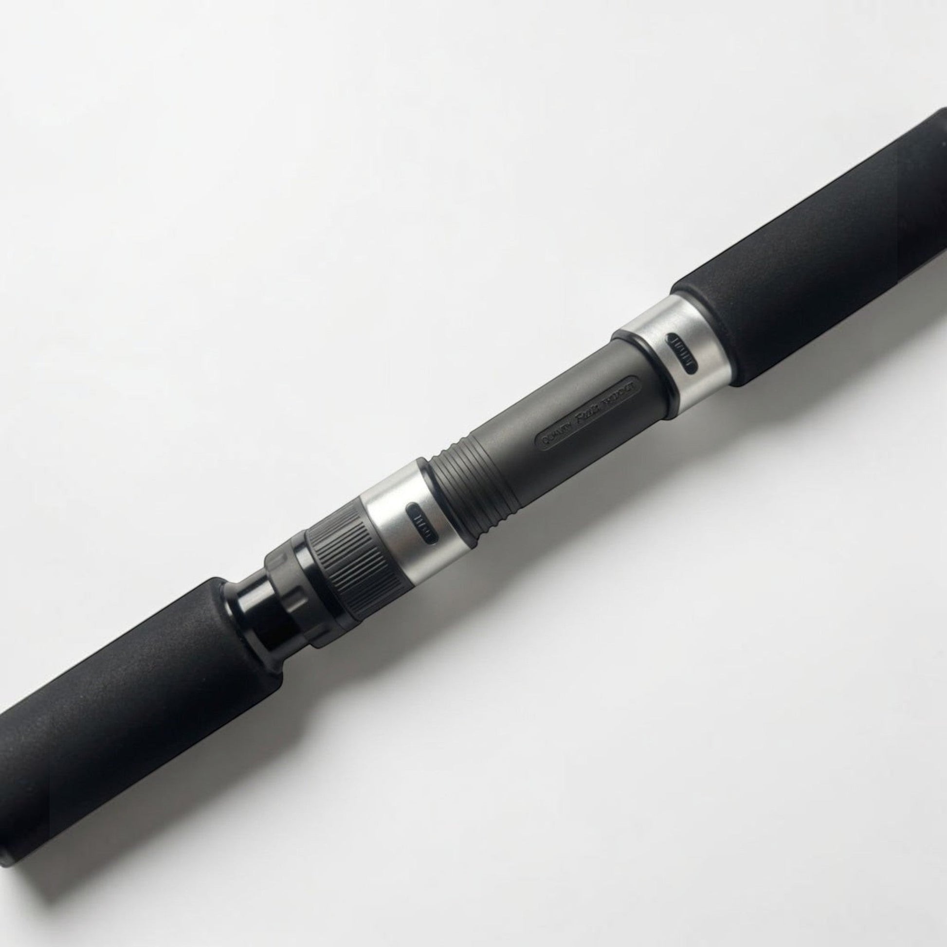 Dogfish Tackle & Marine conventional fishing rod with black EVA foam grips and silver reel seat.