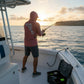 Dogfish Tackle & Marine men's heathered coral long sleeve hooded performance shirt with Florida Unchained logo on back.