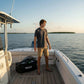 Dogfish Tackle & Marine grey poly cotton jersey short sleeve t-shirt with octopus logo, worn by a young man fishing on a boat.