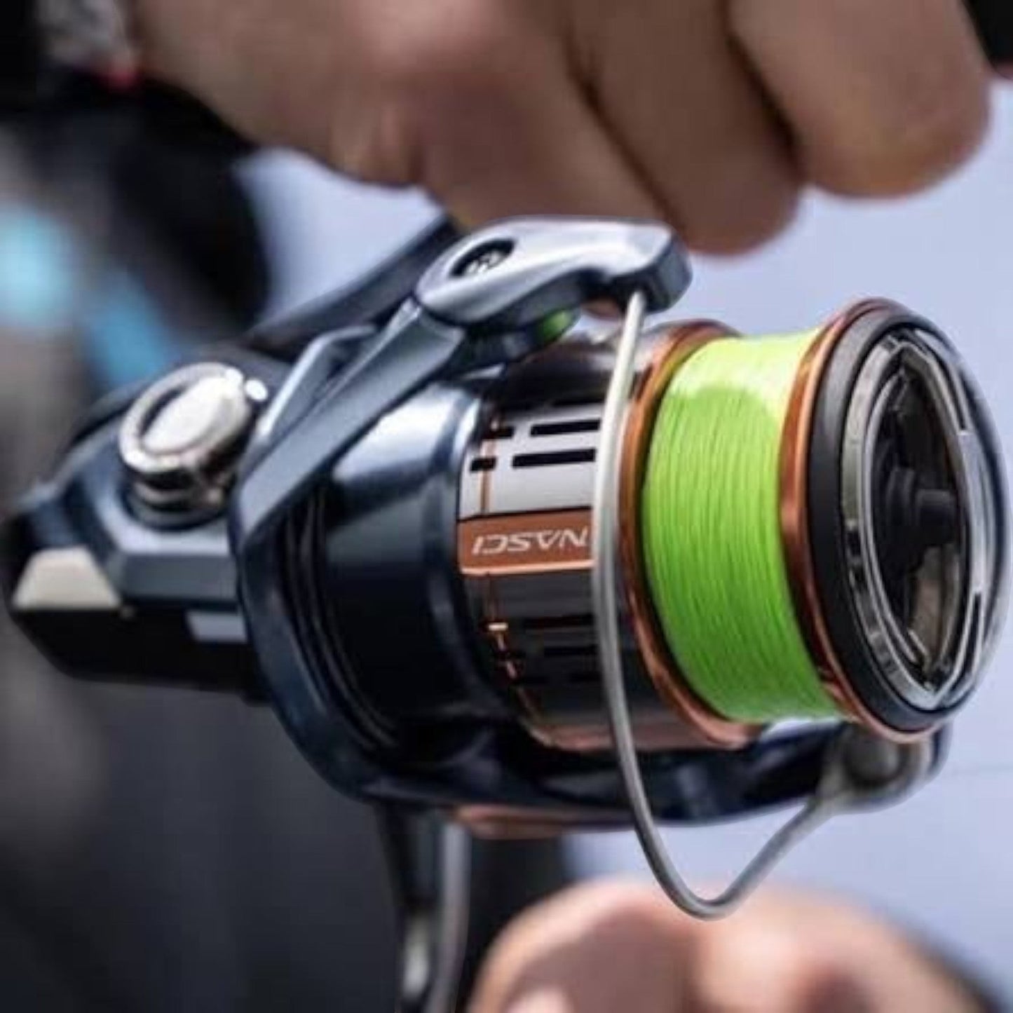 Dogfish Tackle & Marine Shimano Nasci FD spinning reel with neon green fishing line. Features a dark grey body with copper accents.