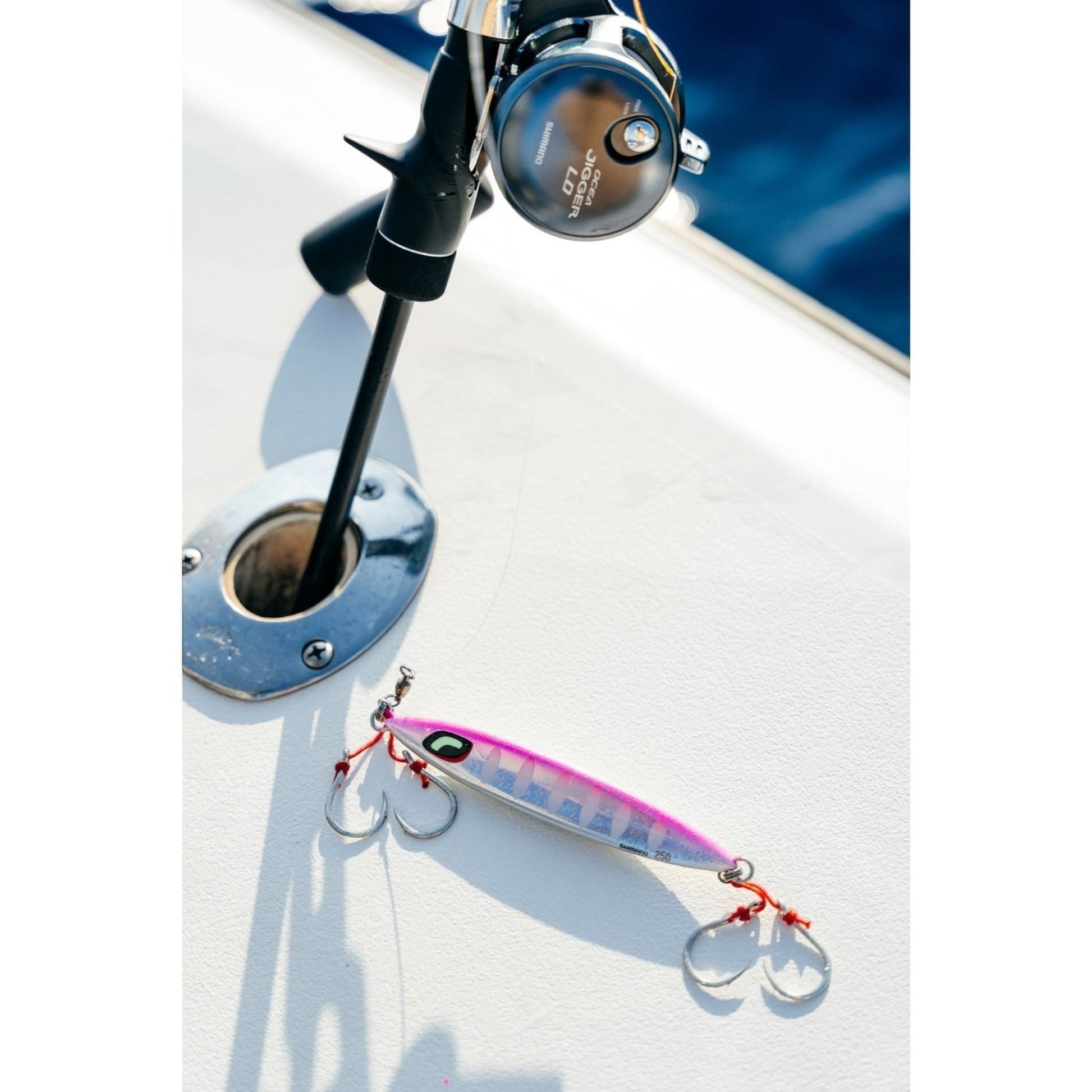 Dogfish Tackle & Marine Shimano Ocea Sardine Waver slow pitch jig in pink and silver with assist hooks on boat deck