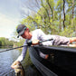 Dogfish Tackle & Marine Shimano SLX DC low profile baitcasting reel with a man holding a fish on a boat.