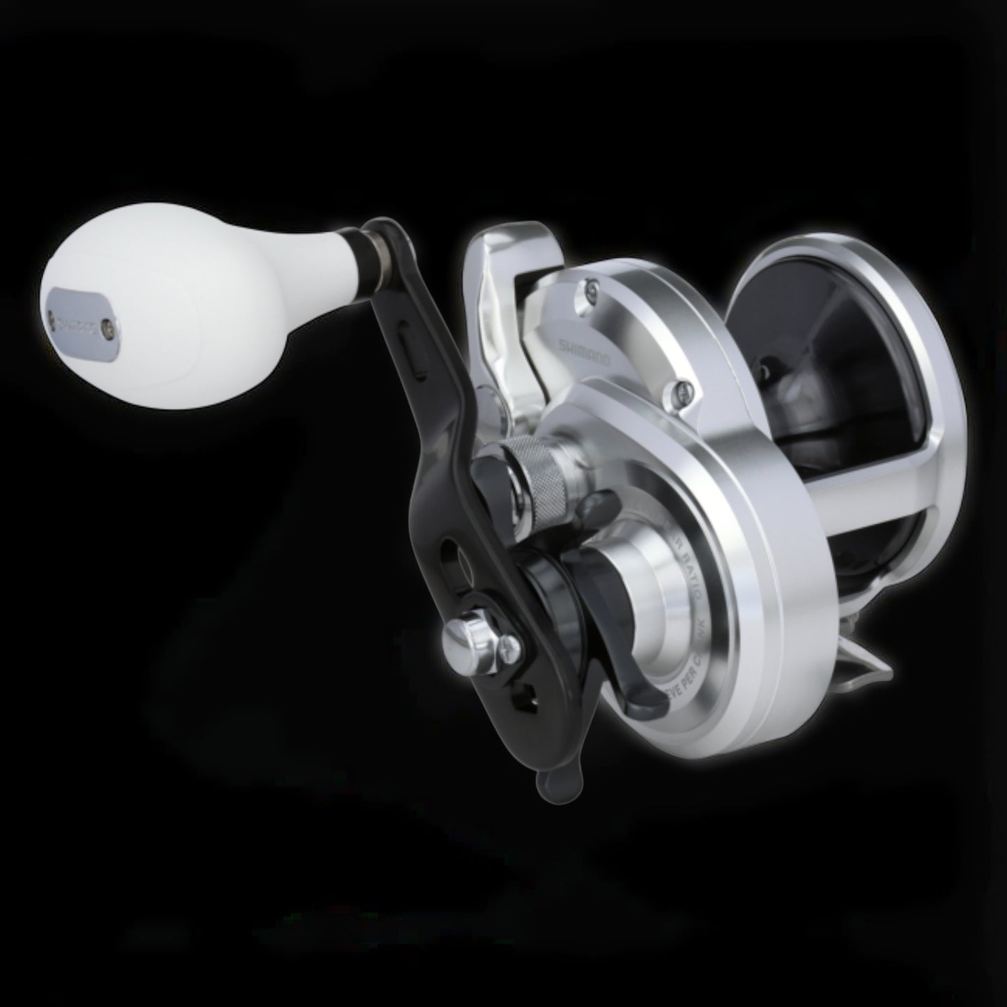 Dogfish Tackle & Marine Shimano Trinidad A conventional fishing reel, silver with a white handle knob and black accents. Features X-Ship and Hagane Body.