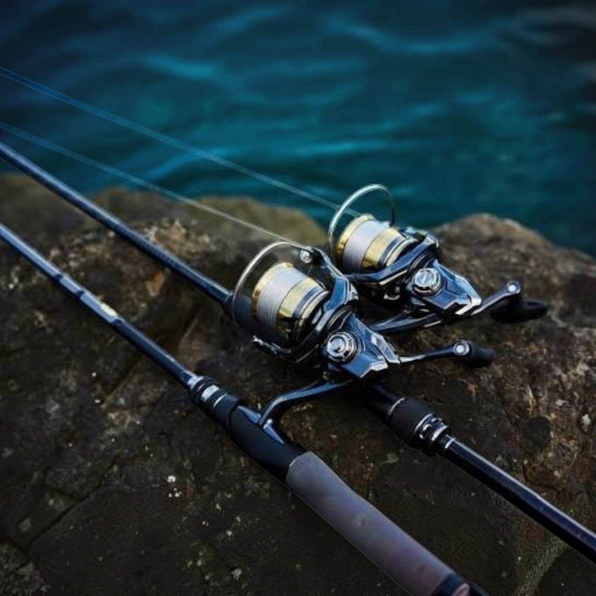 Dogfish Tackle & Marine Shimano Ultegra FD spinning reels with silver and gold spools on rocks near water.