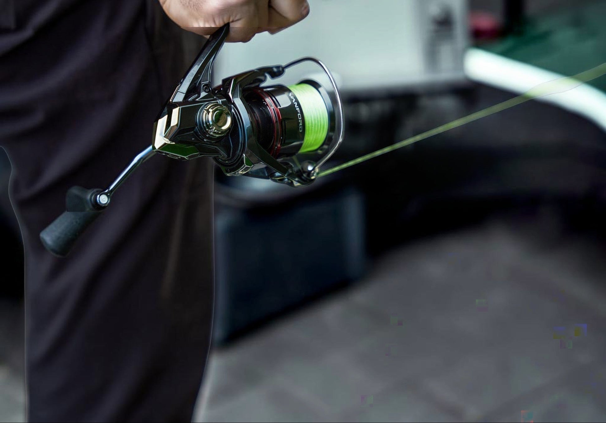Dogfish Tackle & Marine Shimano Vanford FA spinning reel with neon green fishing line, black body, and silver accents.