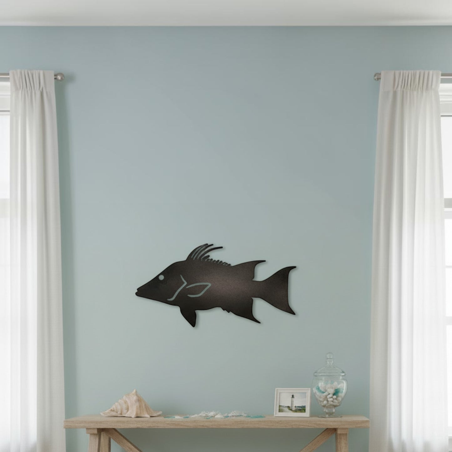 Dogfish Tackle & Marine metal starboard fish wall decor displayed on a light blue wall above a wooden console table.