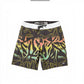 Dogfish Tackle & Marine black boardshorts with abstract yellow, pink, and green print, white waistband, and zip pocket.