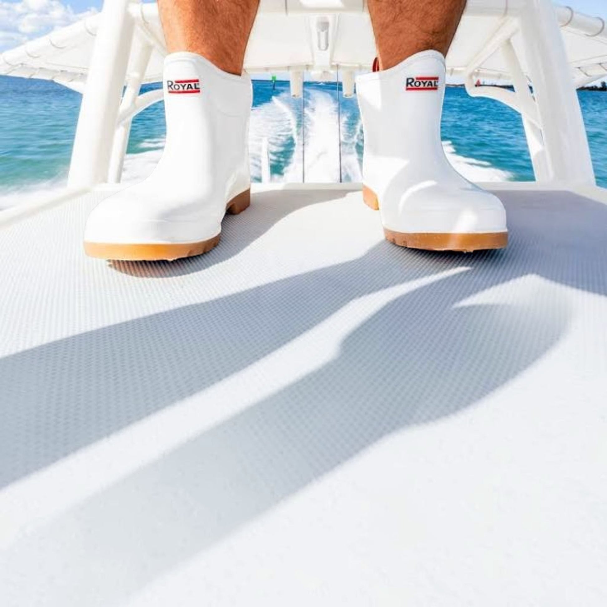 Dogfish Tackle & Marine Royal Mens 6in white waterproof PVC deck boots with deep tread soles worn on a boat deck