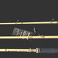 Three fishing rods laid horizontally on a dark wood-grain surface, with one rod fully visible and the other two partially cropped at the top and bottom. A small product tag is attached near the center.