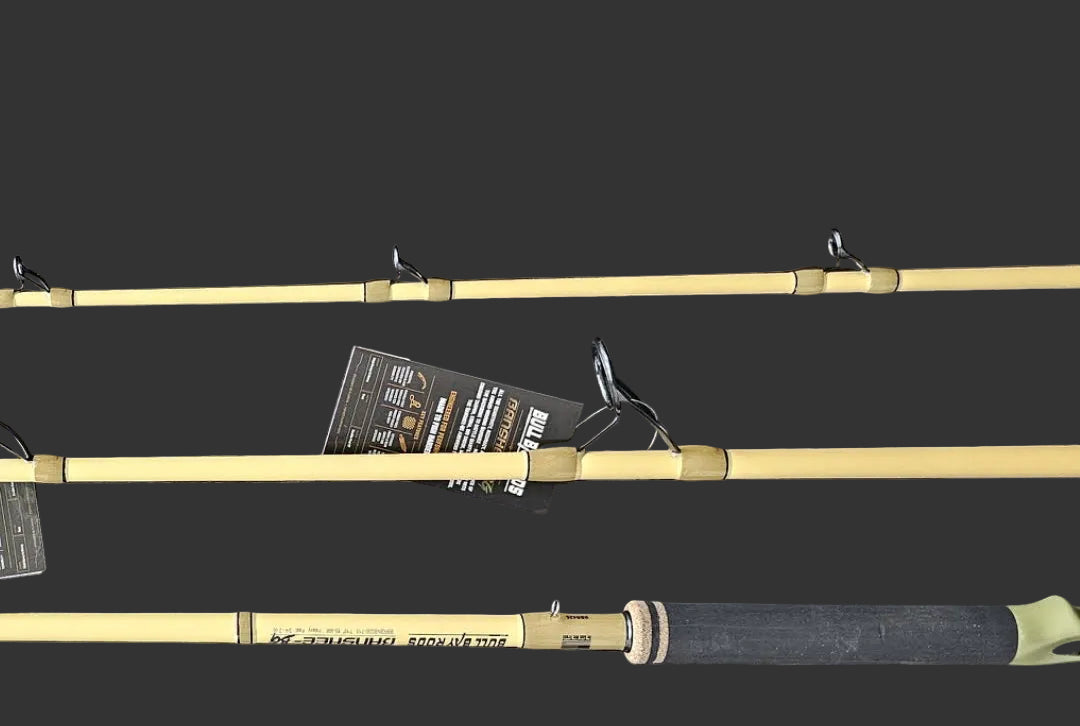 Three fishing rods laid horizontally on a dark wood-grain surface, with one rod fully visible and the other two partially cropped at the top and bottom. A small product tag is attached near the center.